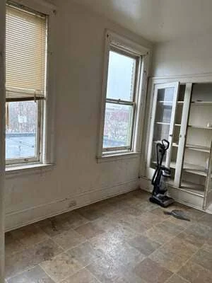 Renovated interior room with new flooring, drywall, windows, and glass-panel doors