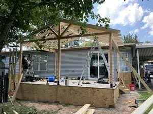 Wood-framed residential addition with engineered posts and beams under construction