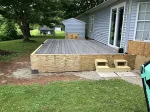 New residential deck with composite decking and concrete foundation footings