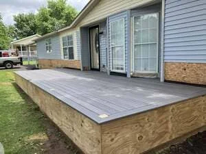 Gray composite deck with wood frame attached to residential home in York, PA